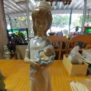 NAO by Lladro  Nurse Holding Newborn baby #709